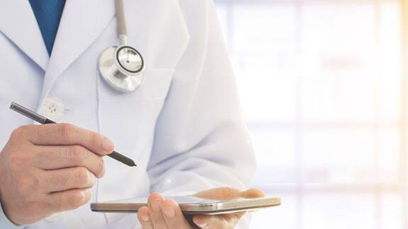 A doctor holding a tablet and a stylus pen