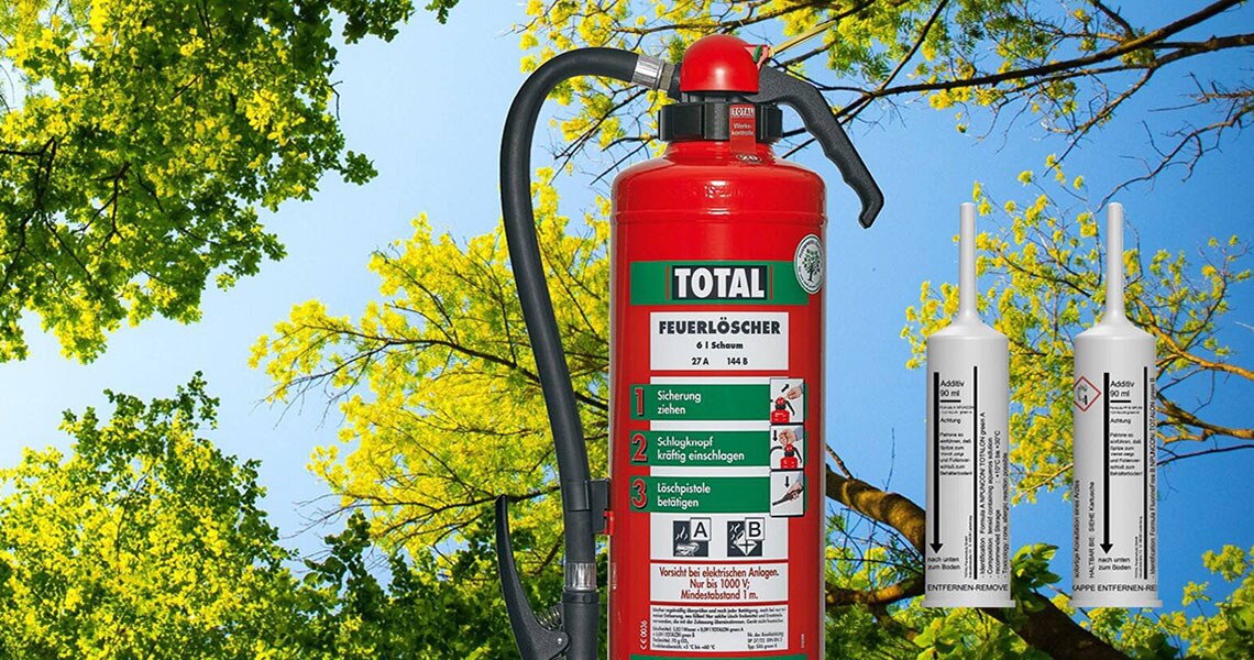 Total fire extinguisher overlaid on an image of green trees