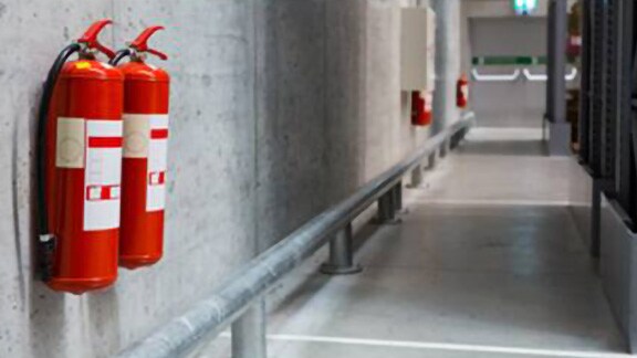 Fire extinguishers installed in a building corridor