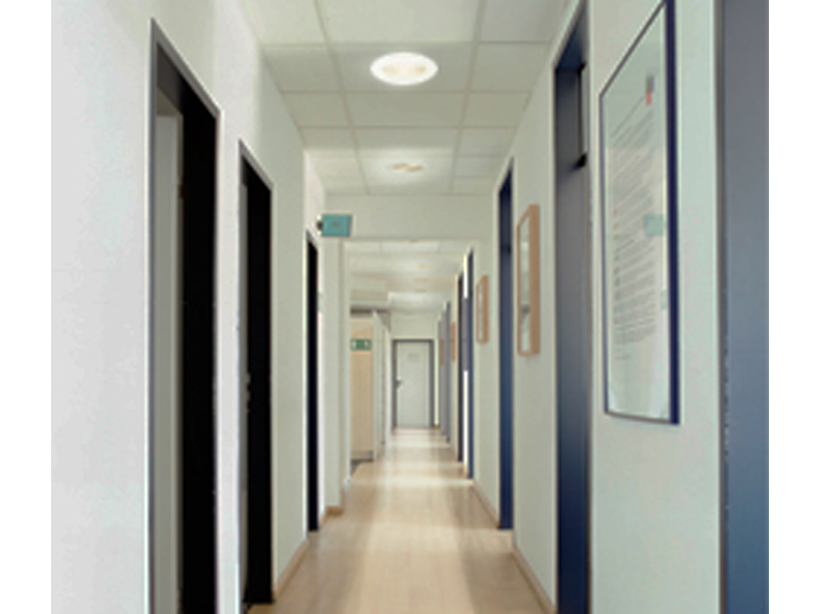 View of a long corridor with rooms on both sides