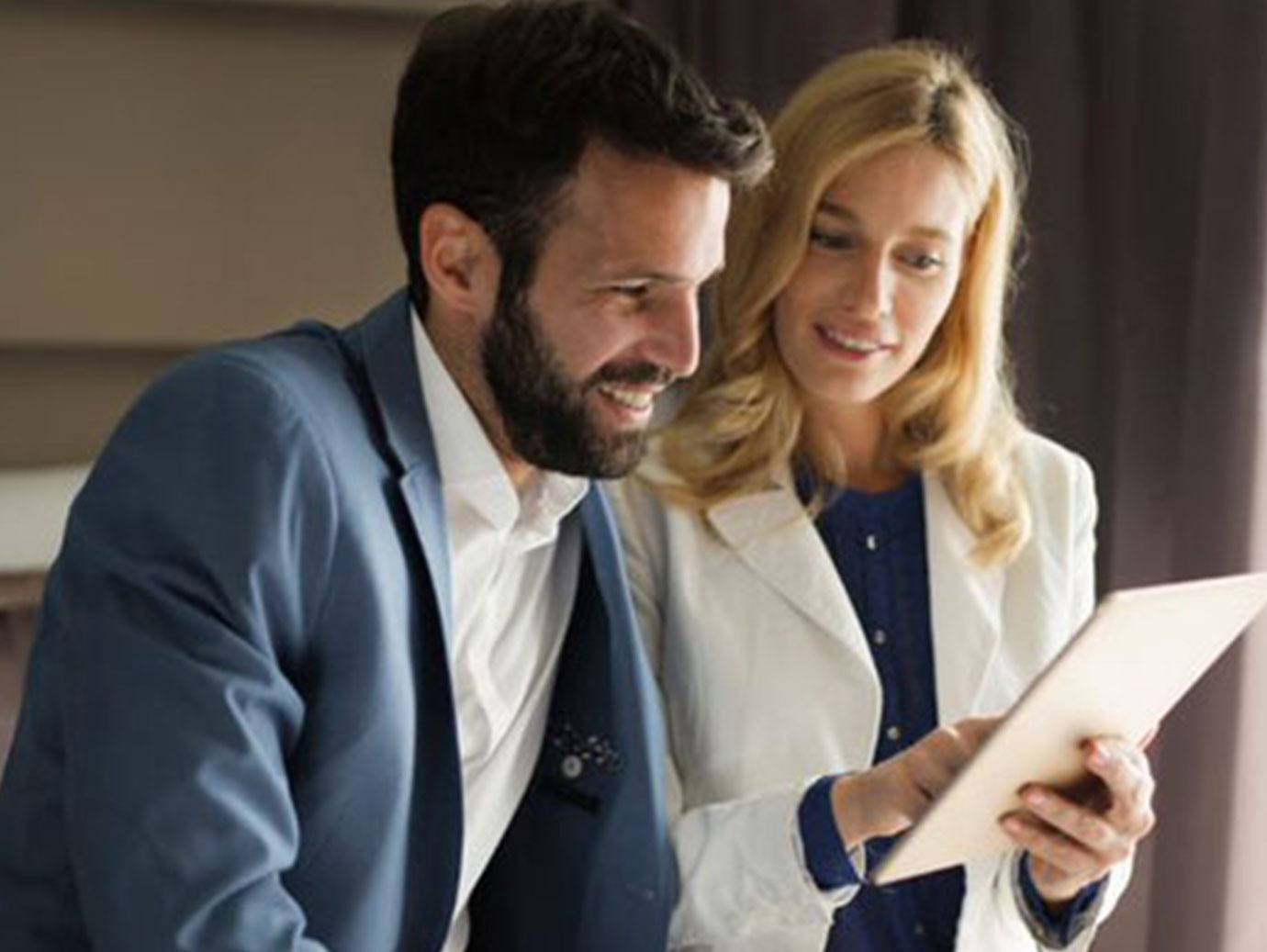 Business man and Woman discussing with a paper in a hotel room