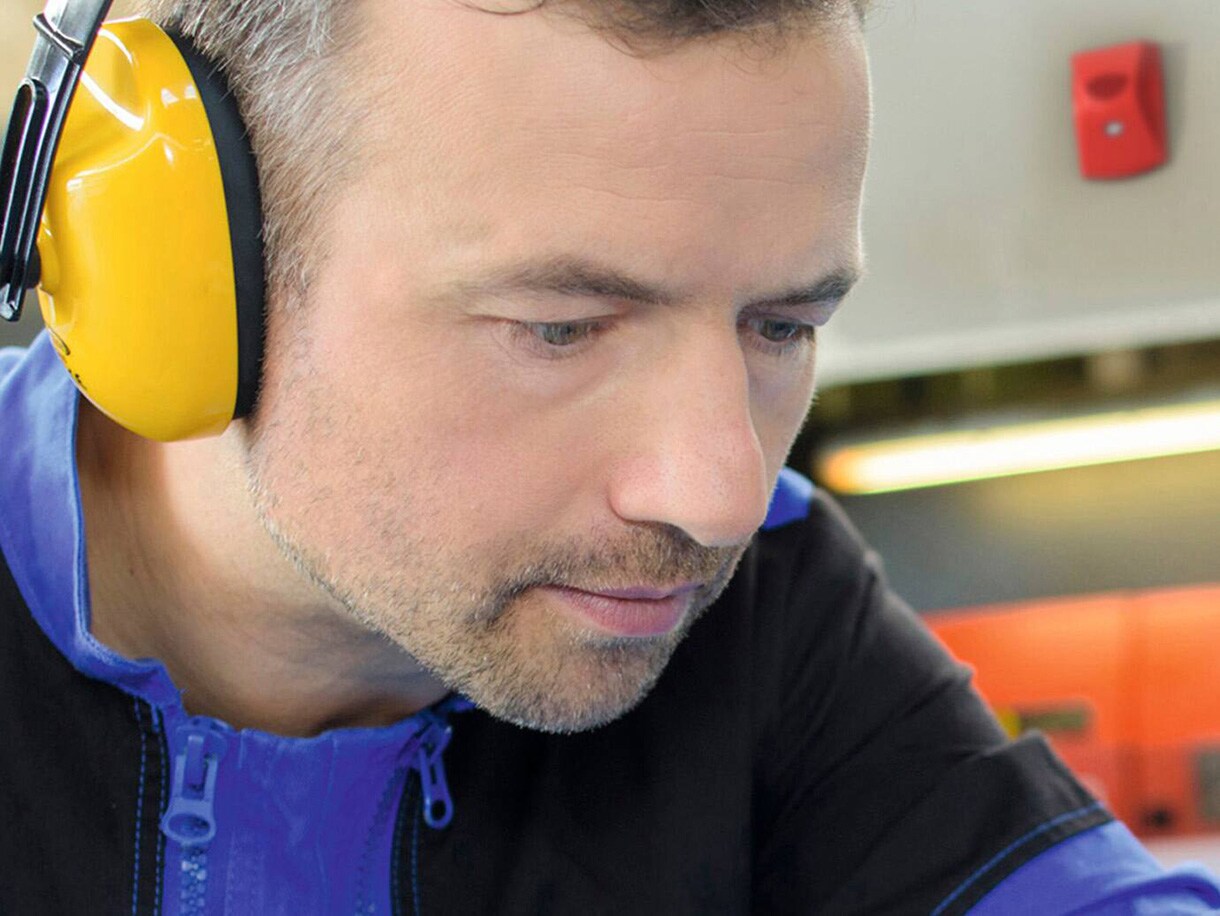 Close-up of a man wearing industrial earmuffs