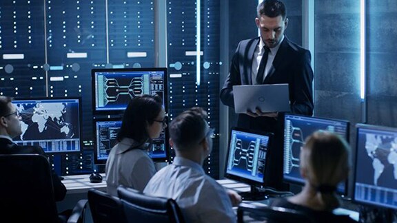 Rear-view image of security officers monitoring cctv footage