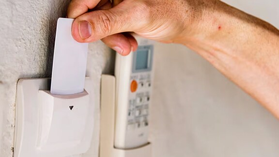 A person using a swipe in card to access