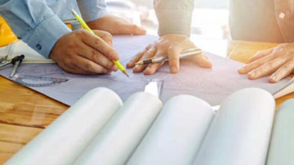 hands-of-architects-working-on-floor-plan