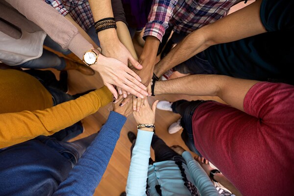 team-huddled-hands-middle_v2