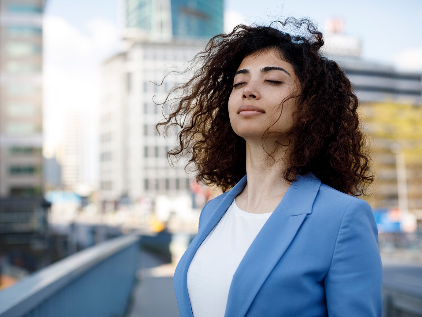 A woman standing with her eyes closed