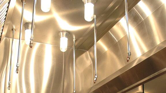 Fire suppression systems installed on the ceiling of a commercial kitchen