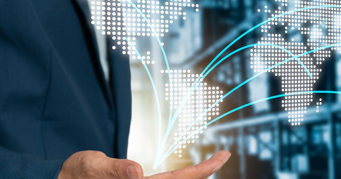 Graphic of a world map springing out from the palm of a businessman