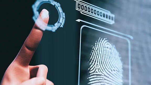 A person touches the biometric scanner for access