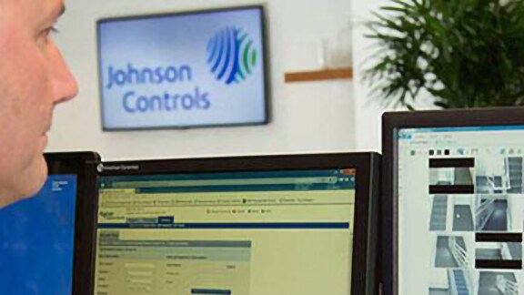 An employee is monitoring the cctv footages in the Johnson Controls office