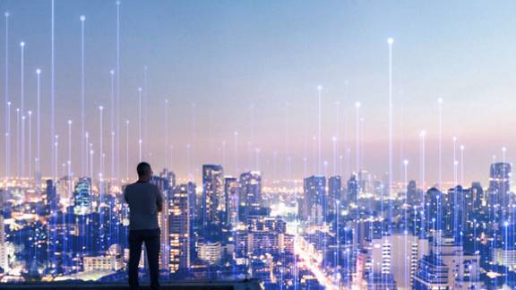 A person standing on a rooftop overlooking a city
