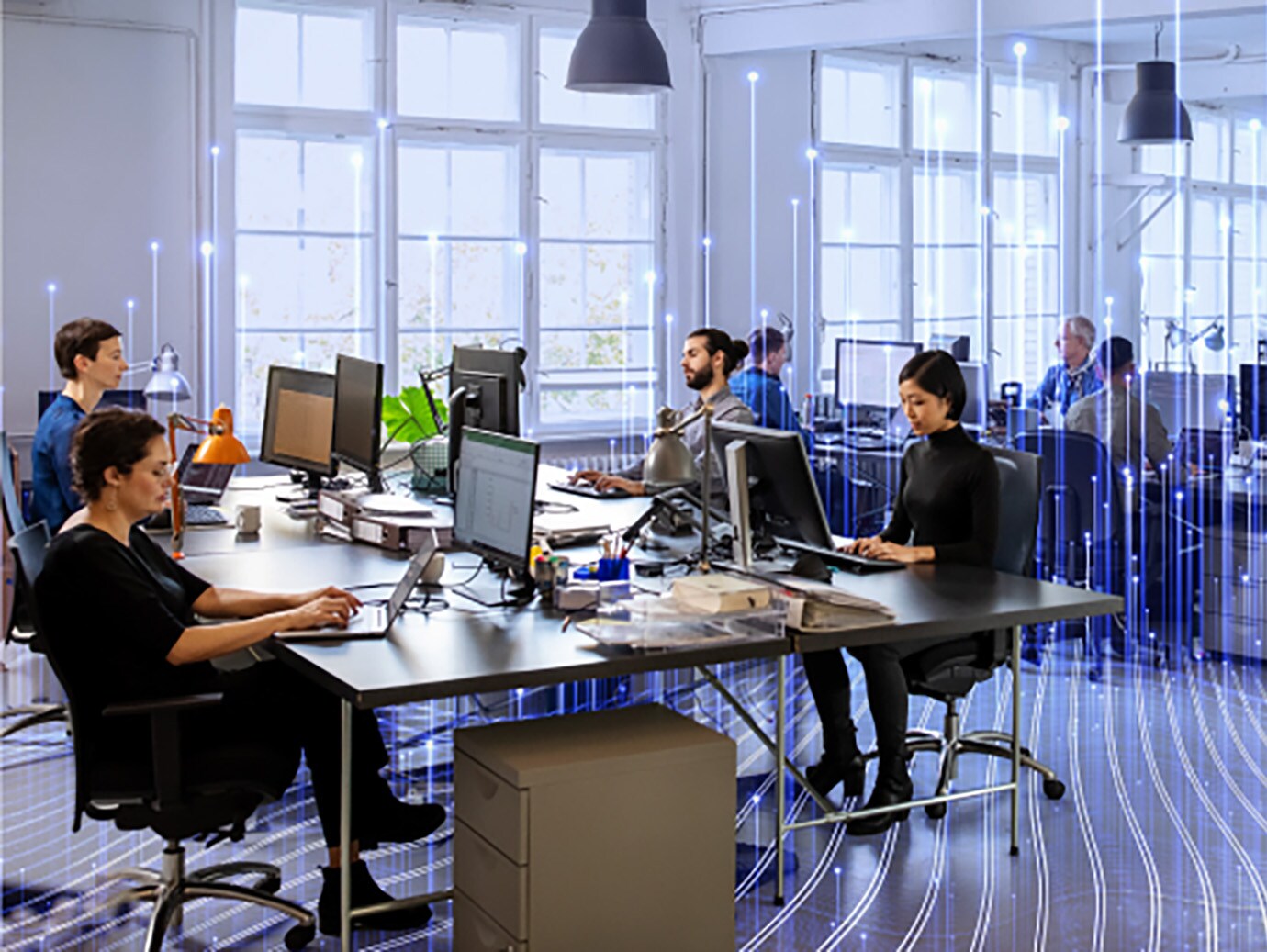 Employees working on desktops in office, overlaid with a graphic of transmission nodes
